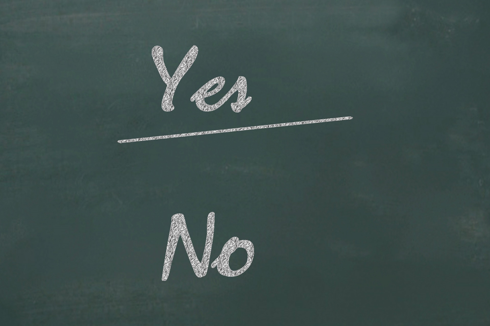 A blackboard written with 'Yes' and 'No', with yes underlined on it.