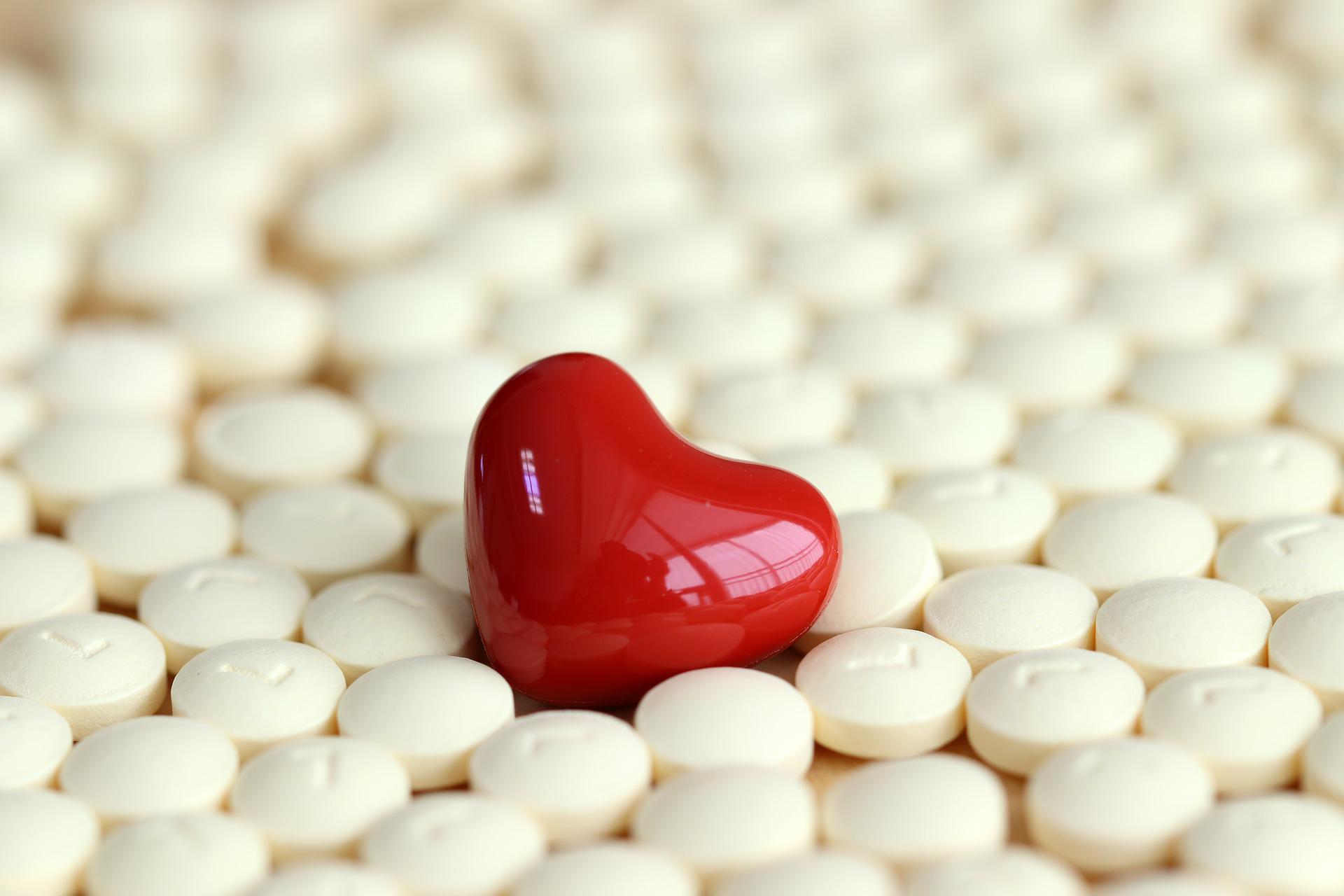 Heart shaped medicine in a pile of medicines